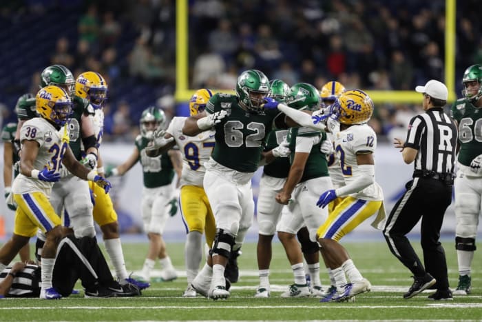 Dec 26, 2019; Pitt Panthers defensive back Paris Ford (12) grabs the facemask of Eastern Michigan Eagles offensive lineman Sidy Sow (62). Mandatory Credit: Raj Mehta-USA TODAY